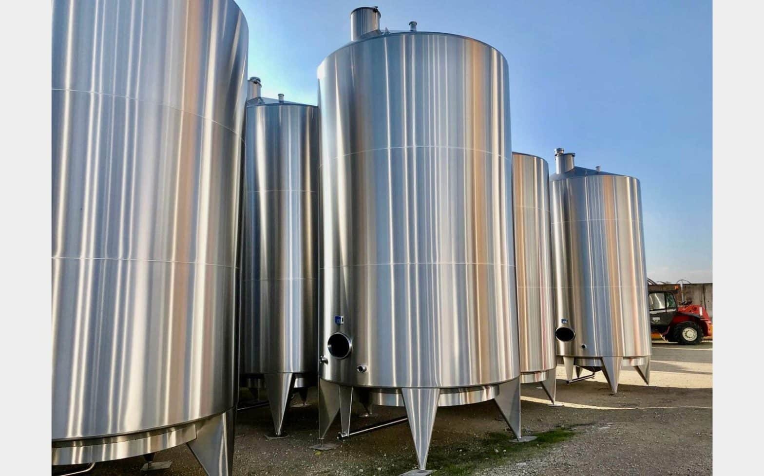 A group of a large metal tanks sitting next each other.