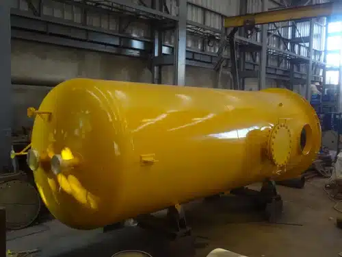 yellow tank sitting inside of a factory