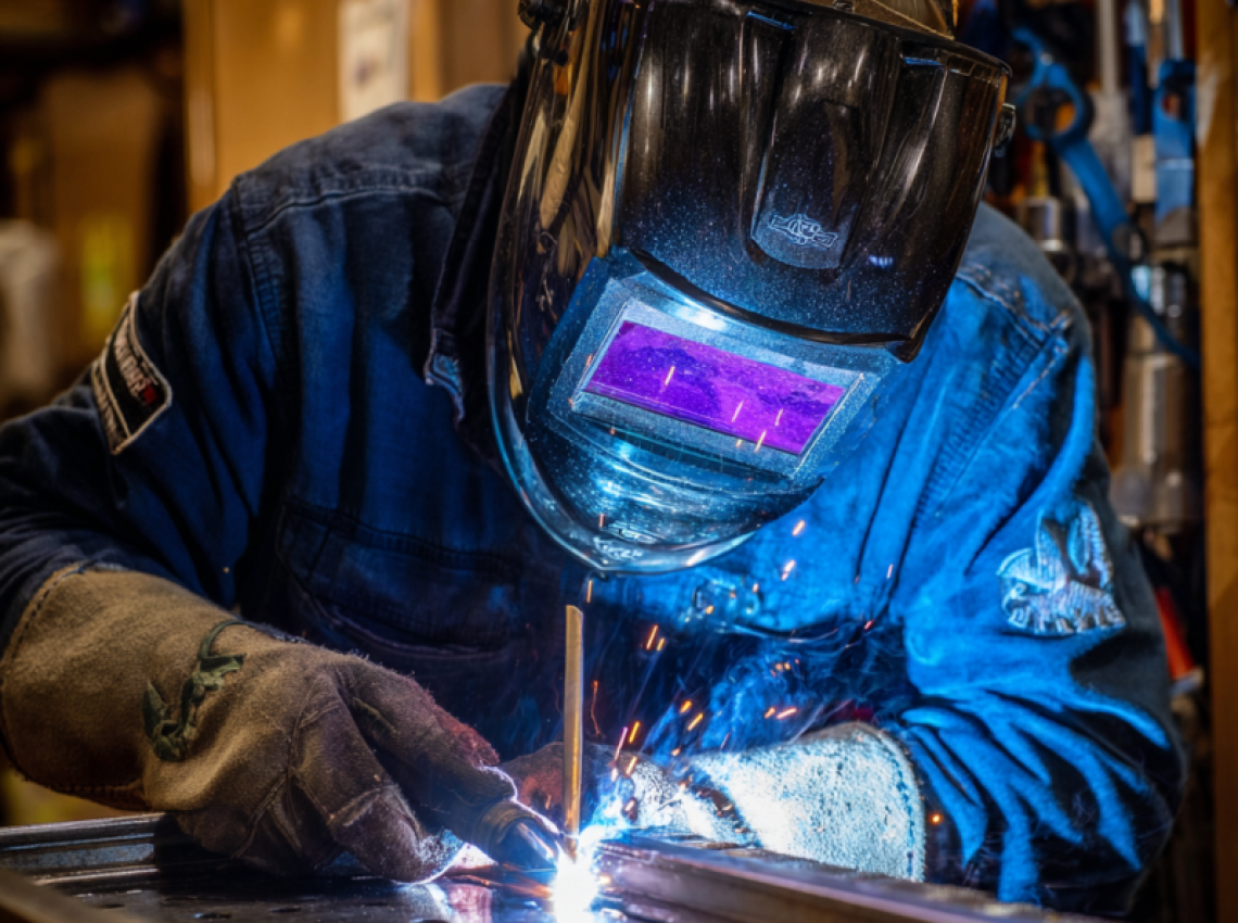 Welder demonstrating 3G welding position techniques