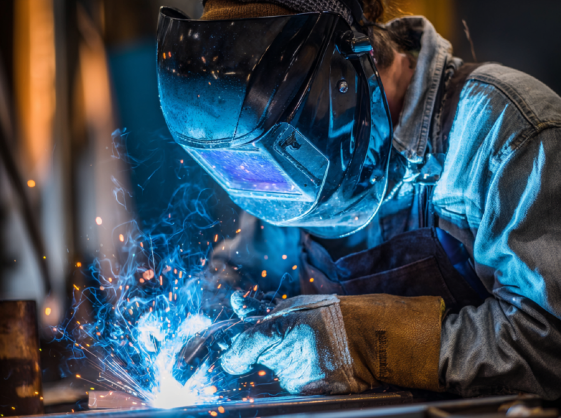 Welder performing 4G welding position overhead weld