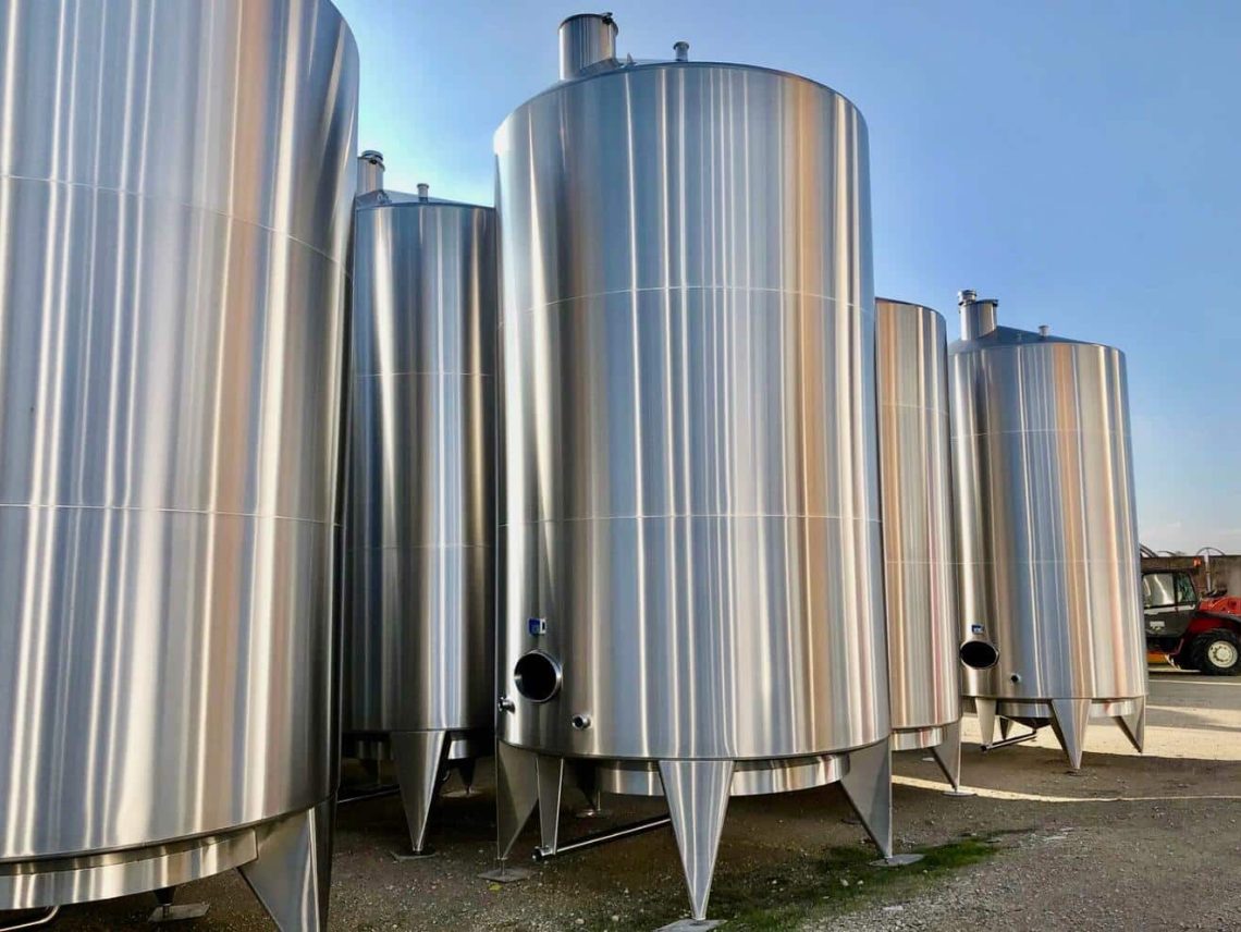 A group of a large metal tanks sitting next each other.