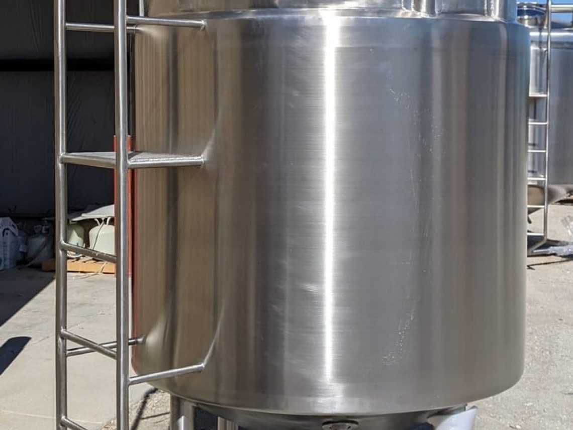 a large metal tank sitting outside of a building