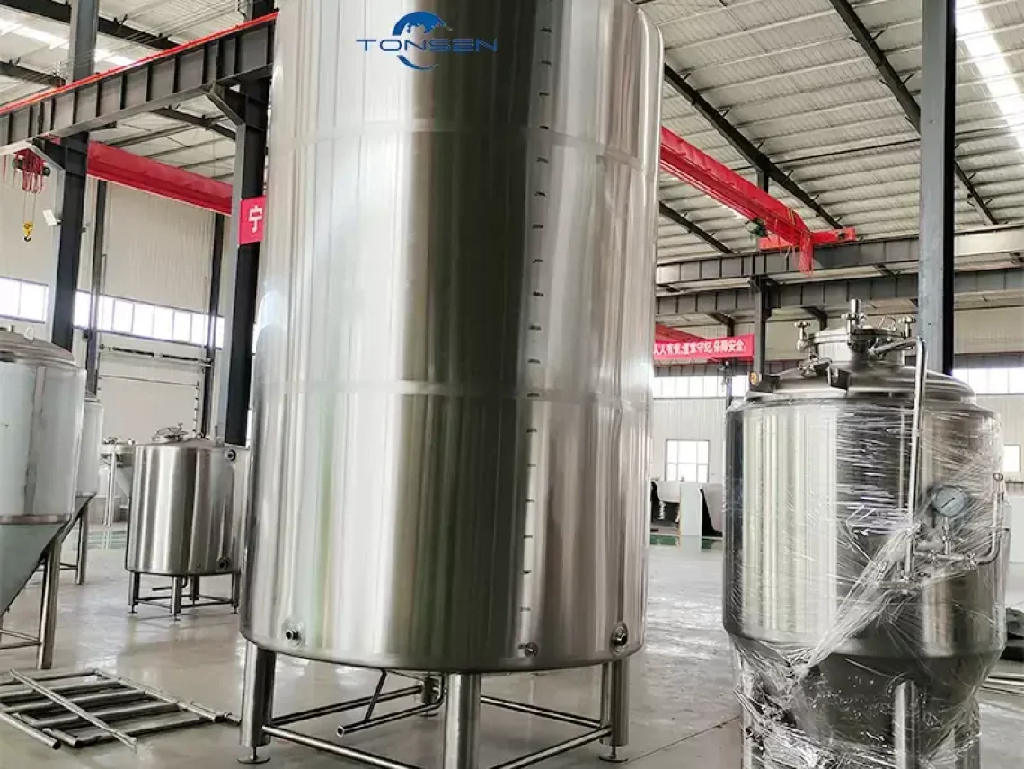 a large stainless steel tank in a warehouse