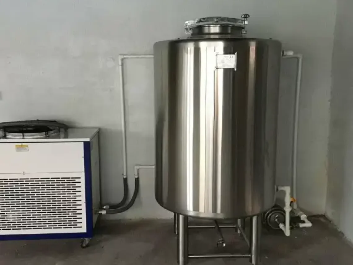 a large stainless steel tank next to a heater