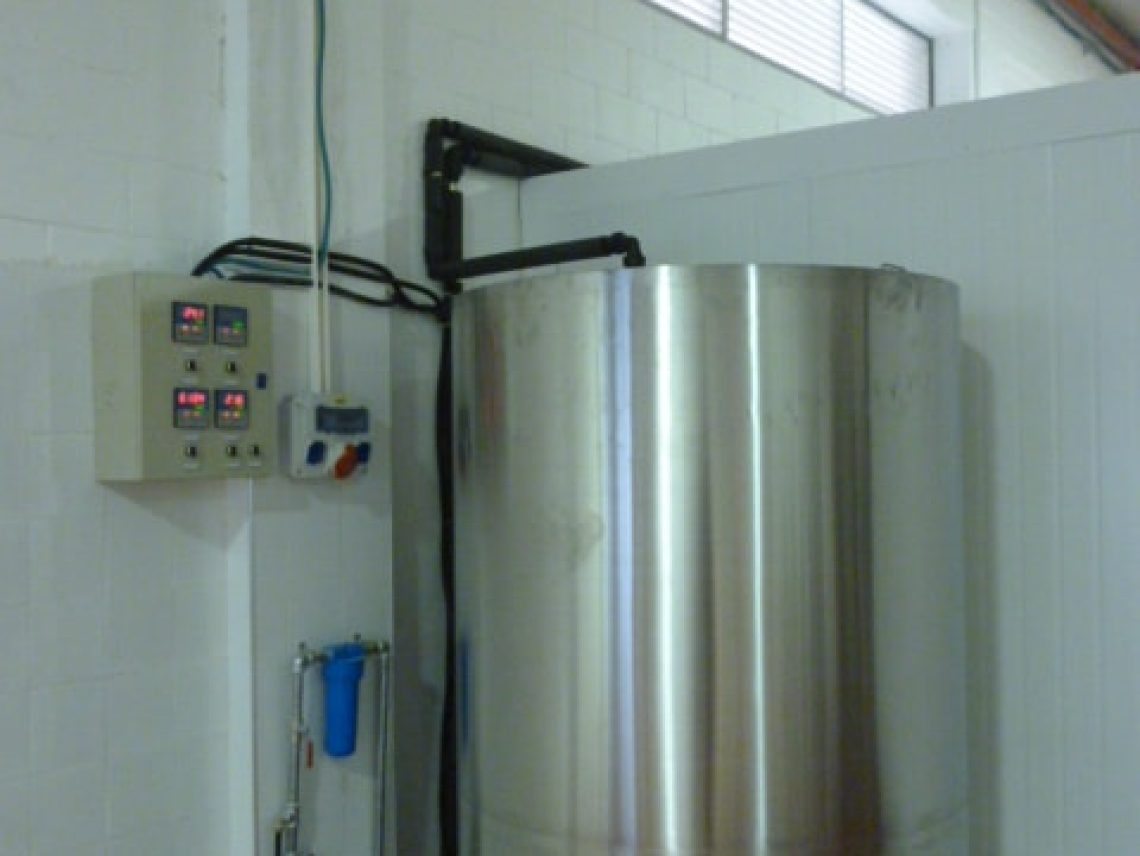 a large stainless steel tank sitting in a room.