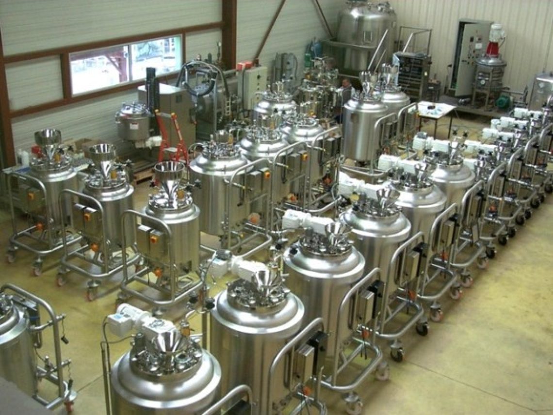 a room filled with lots of stainless steel tanks