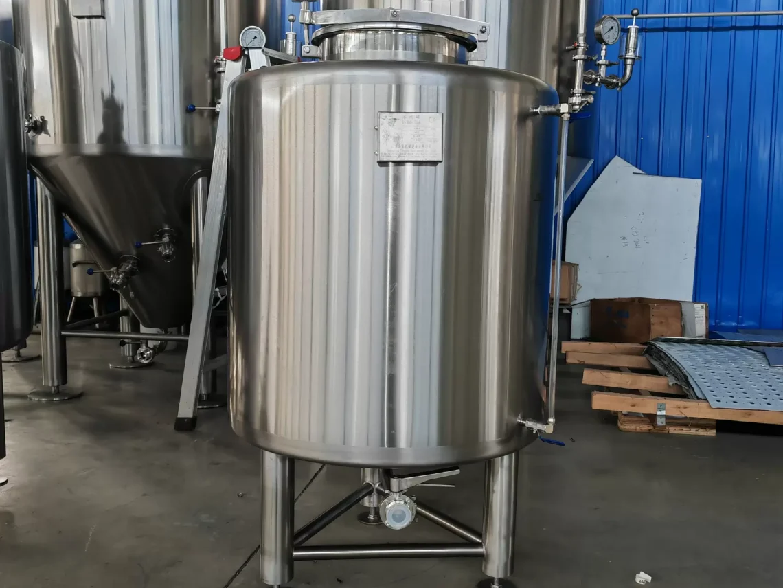 two large stainless steel tanks in a warehouse