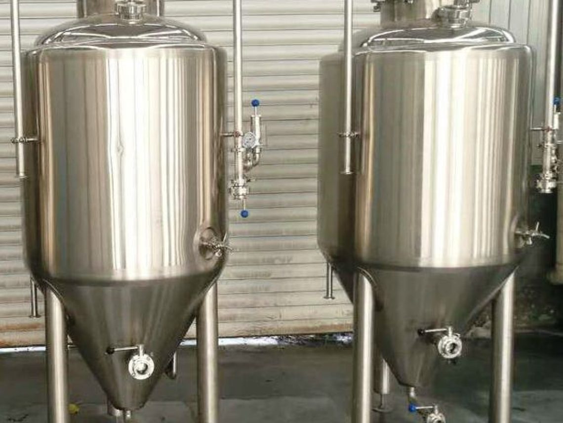 Two stainless steel tanks sitting next to each other