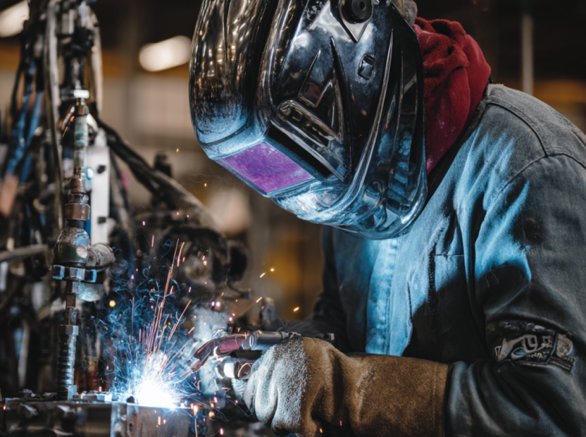 Welder demonstrating what is 4g welding position with overhead weld