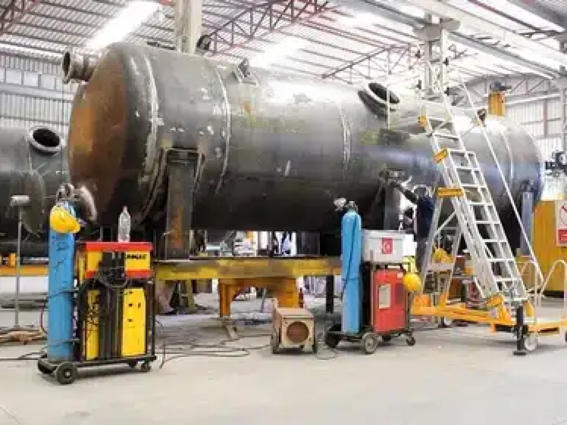 a large metal tank being worked on in a factory