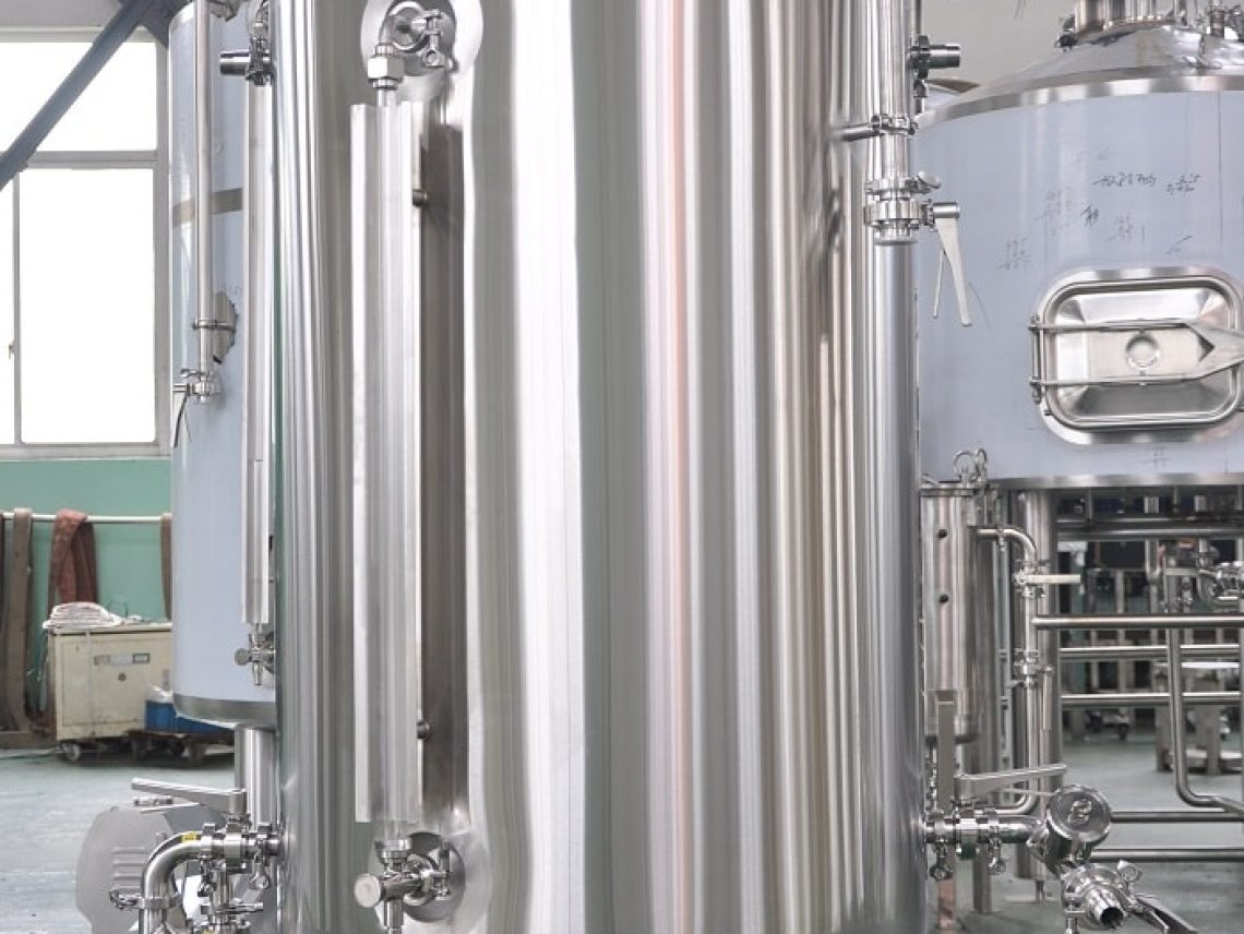 a large stainless steel tank sitting inside of a building